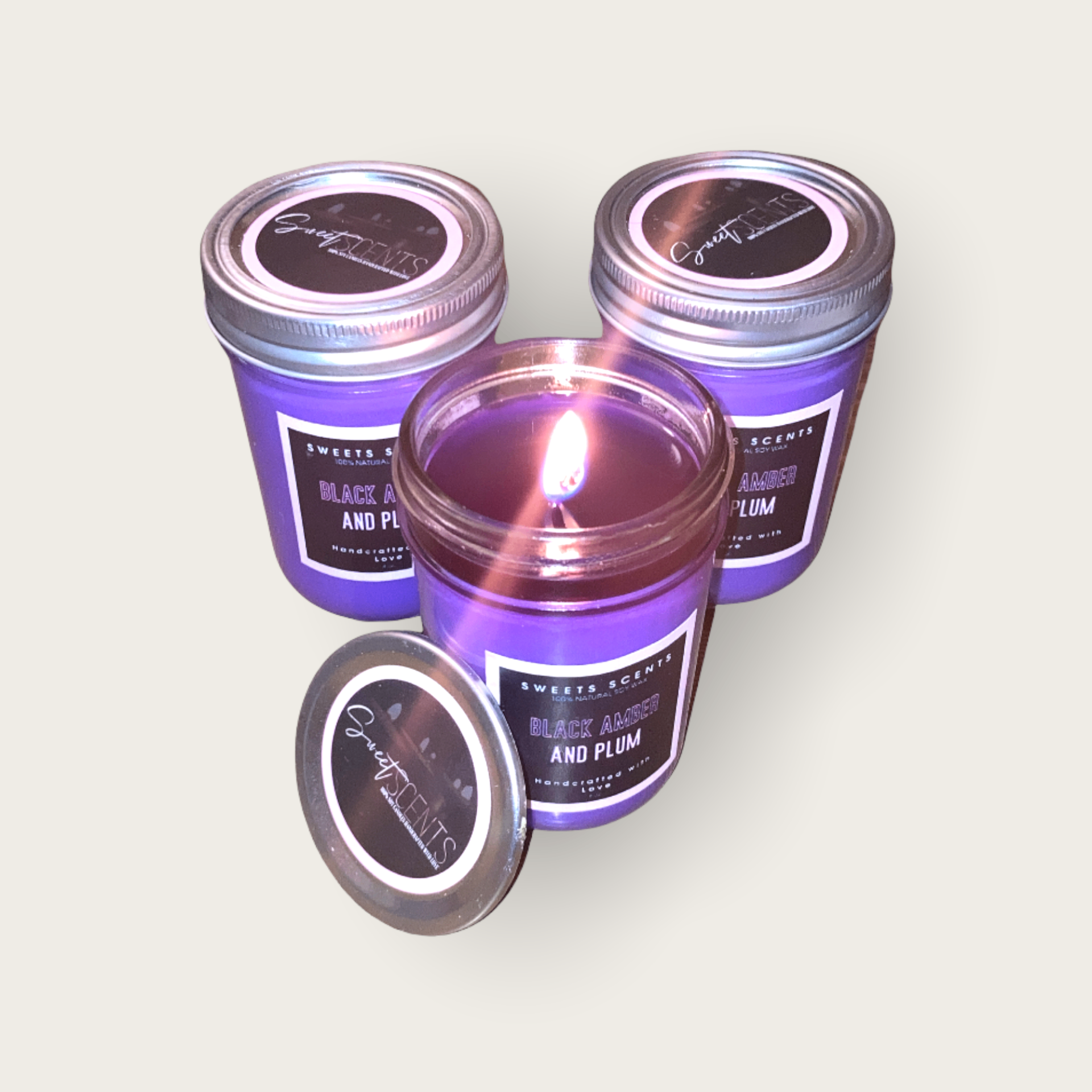 Black Amber and Plum soy candle in a glass jar